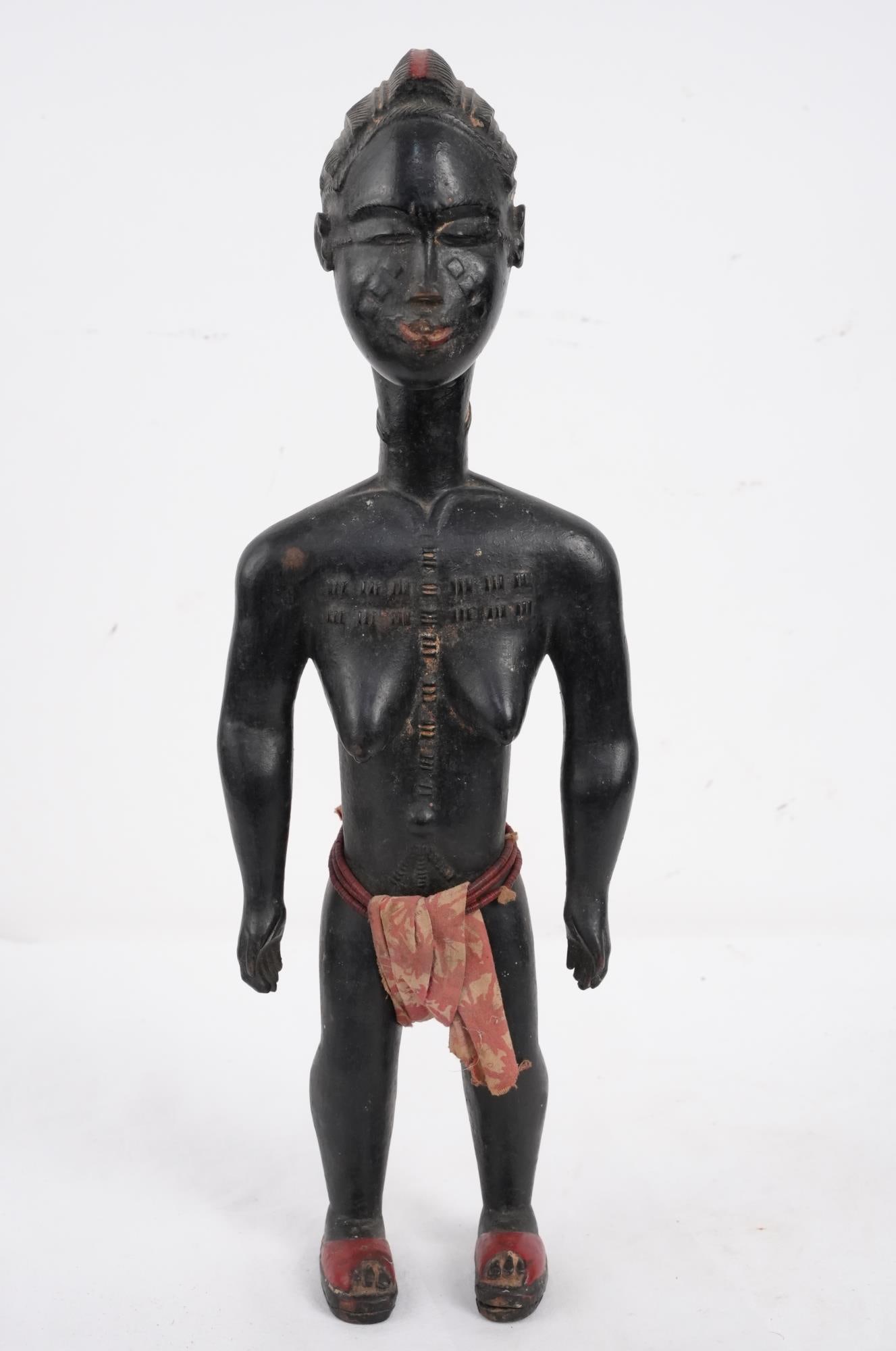 African female figure w red line in hair: w skirt -16" x 5.5" x 3.5" Provenance: Important Montecito estate collection