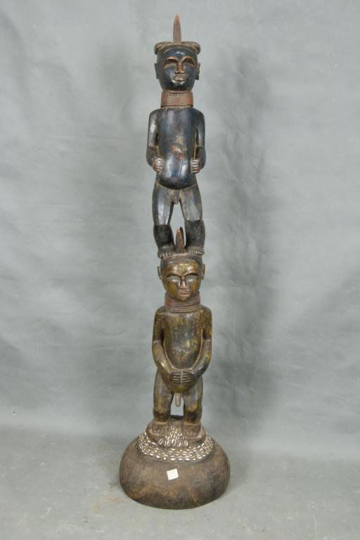 Bocongo - Brazzaville Museum appr. 90 yrs old: statue of 2 figures standing on each other with cowrie shell base, polychrome paint; stand at 5'; from the Daniels's Den Museum collection