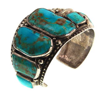 Signed Navajo Blue Gem Turquoise & Silver Bracelet: A large masterpiece with 'Blue Gem Turquoise' mounted on a Sterling Silver Cast Cuff Bracelet, Navajo artist hallmark 'R' (Probably Roy Buck) and marked sterling. Provenance: Former Football player,