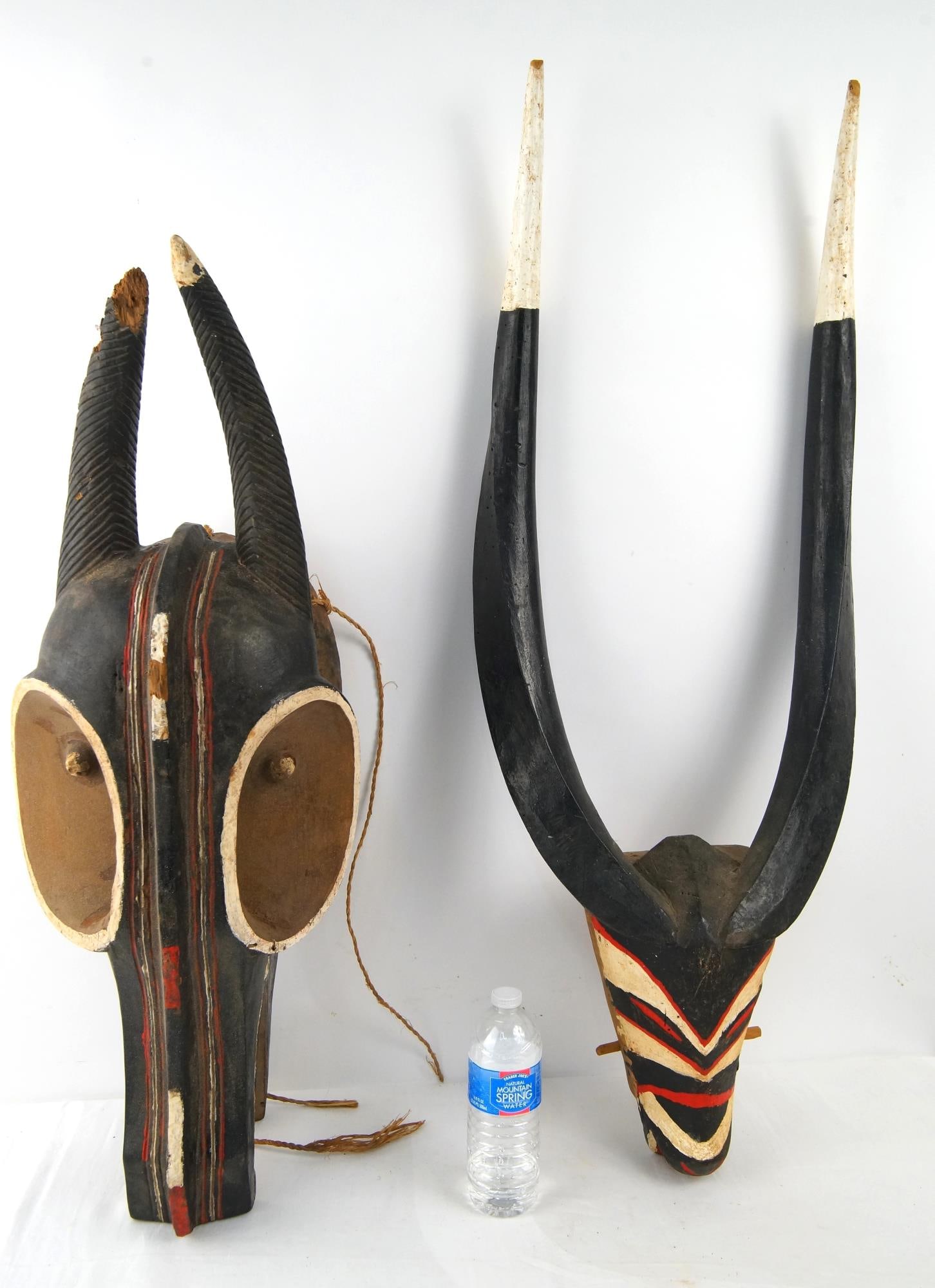 Baule Goli Glin Oversized Helmet Masks - 2: Wood Carved with horns, bright original paint they measure 32.5" x 15" x 10" and 40" x 15" x 6" Provenance: Important Montecito estate collection