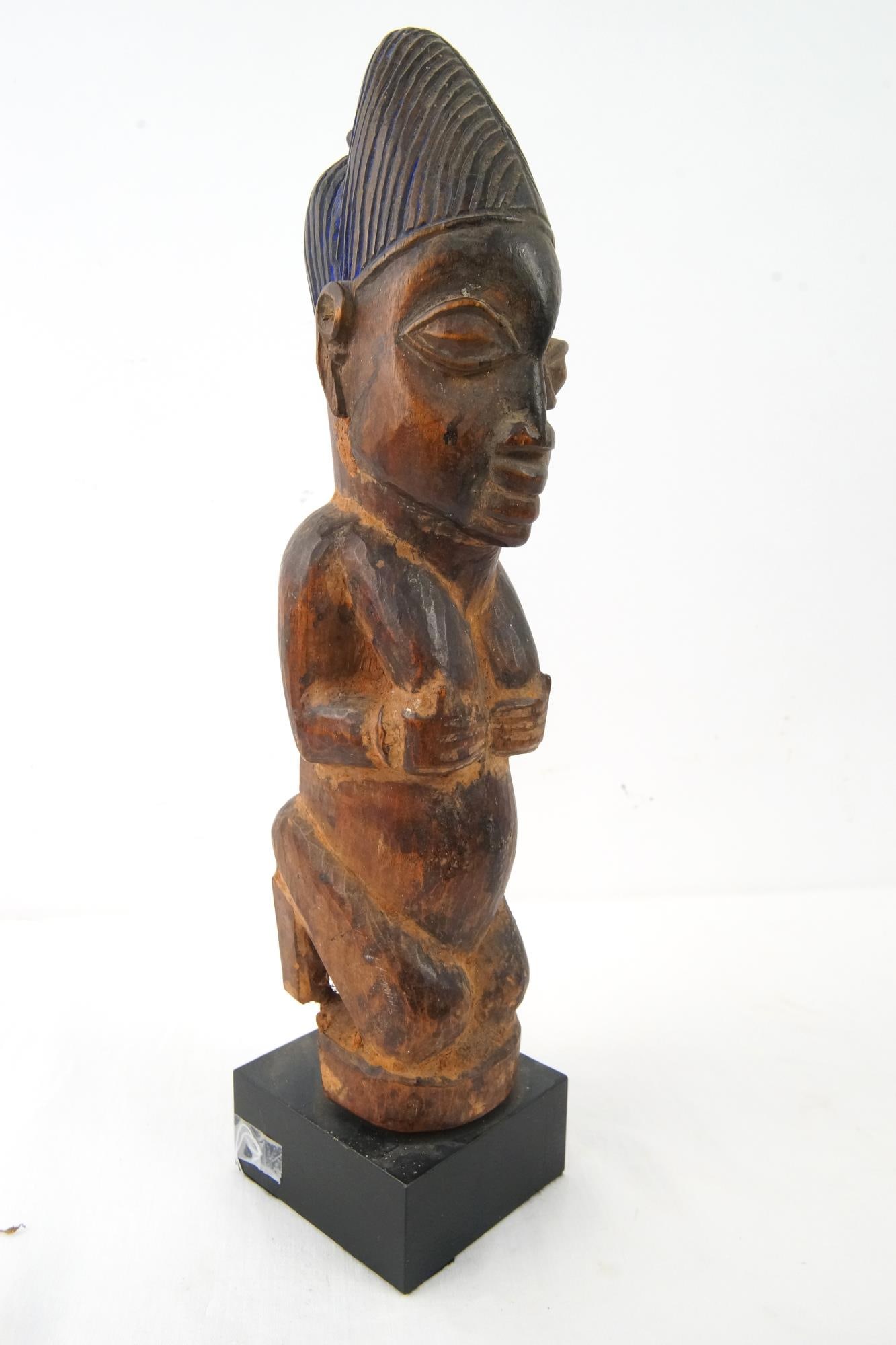 Yoruba Ancestral Female Figure Kneeling NO RESERVE: Wood carved with a blue, brown and black painted patina that shows age measures approx. 15" x 4" on a 2" stand