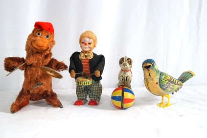 Four wind up vintage post war toys
