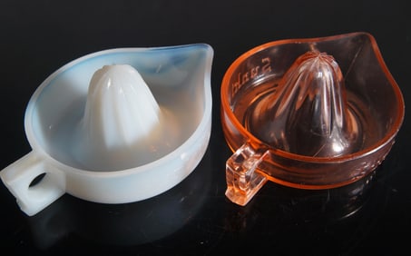 Two McKee Glass Sunkist Pink and Fry Opal Reamers