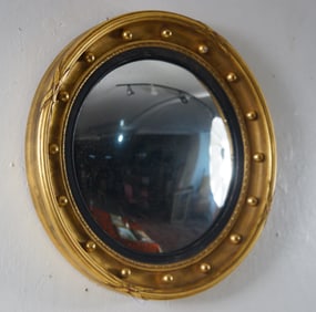 Regency Style gilded and ebonized convex mirror