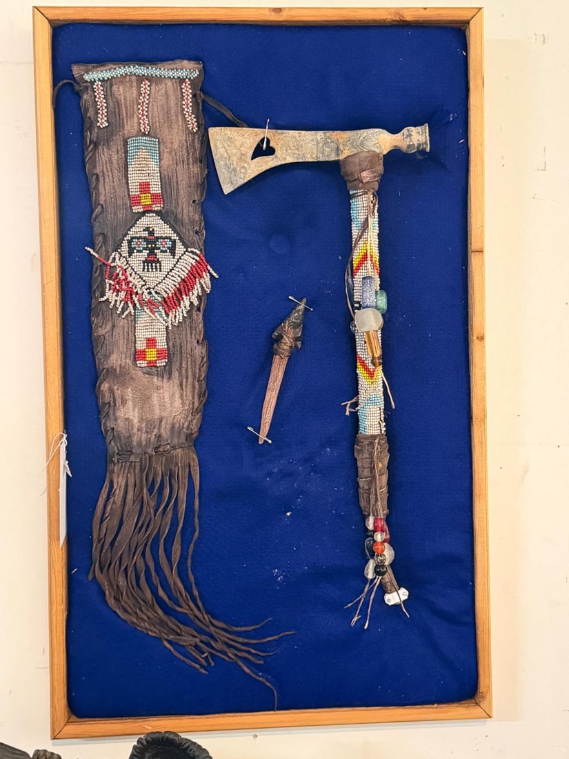 Encased Native Tomahawk & beaded tobacco bag: Native presentation with beaded tobacco back, tomahawk with rawhide and stag horn and obsidian point tethered to a stag horn in a 36" x 20" Provenance: The Estate of Jim Grimm Sta Barbara County Ca