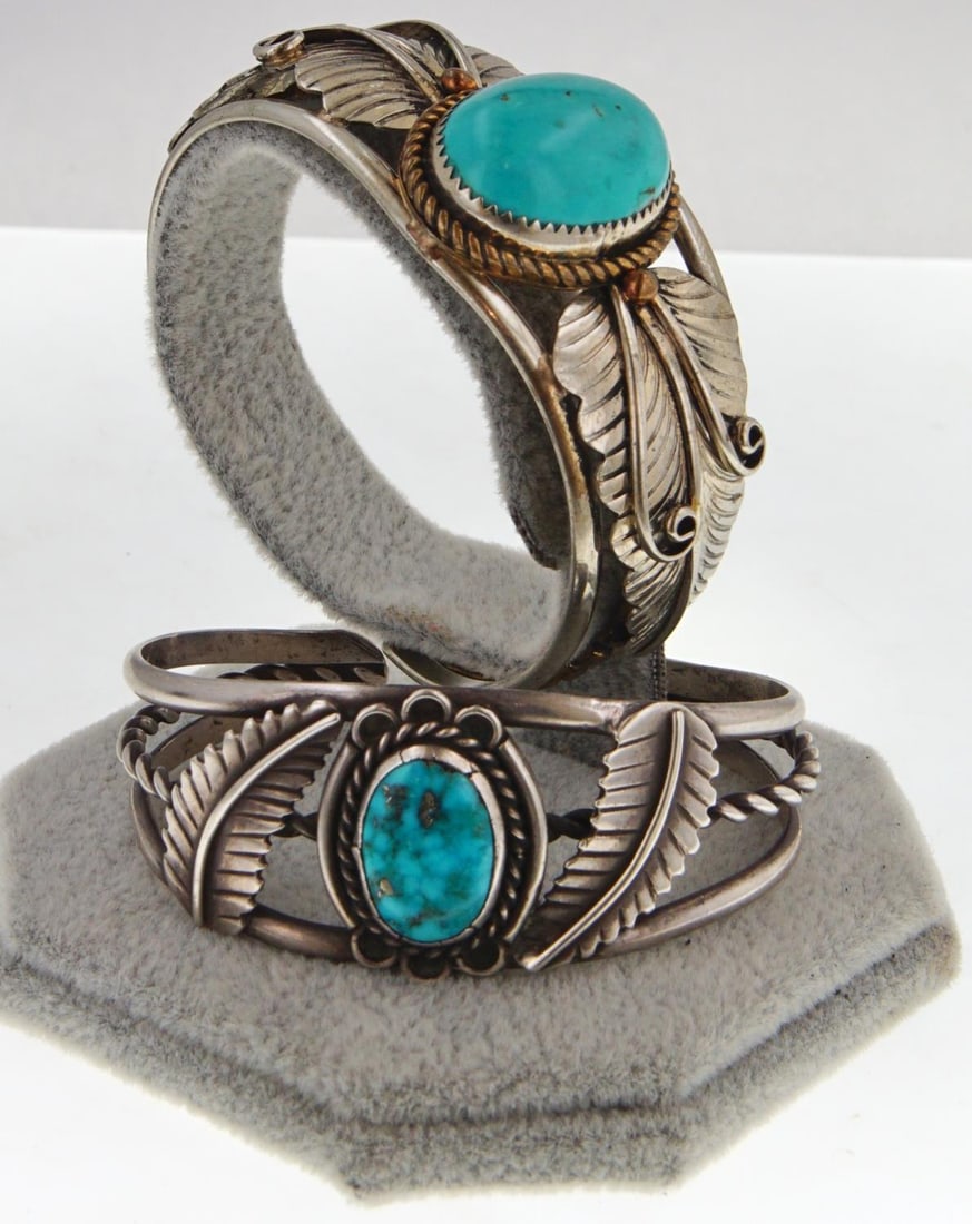 Two Navajo silver & turquoise bracelets: Silver bracelets with feathers one has a larger sleeping beauty cabochon turquoise oval stone and copper repeating beads, the other is a green veined spider web turquoise (probably Kingman) and