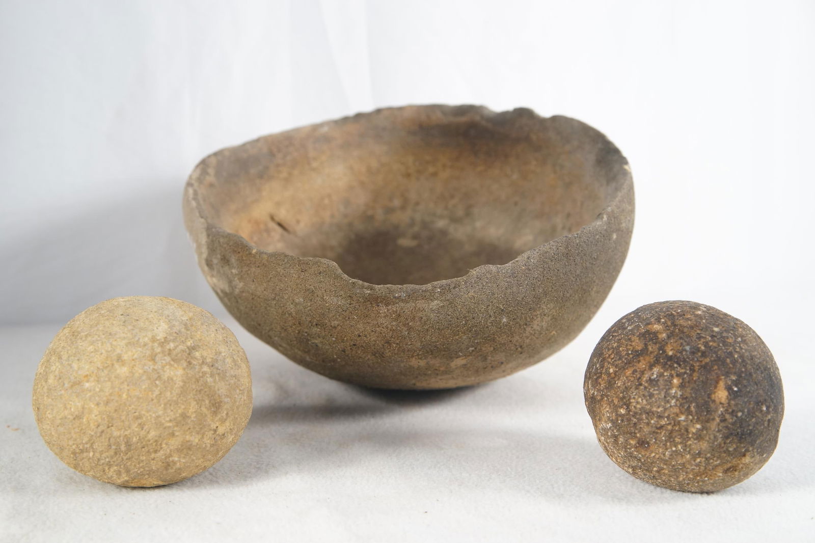 Ancient Native Round metate with 2 round mano: Includes two 4" diameter manos - measures 10" x 9.5" x 6.5" Provenance: Museum of the Cowboy "Jim Grimm estate" Solvang Ca.