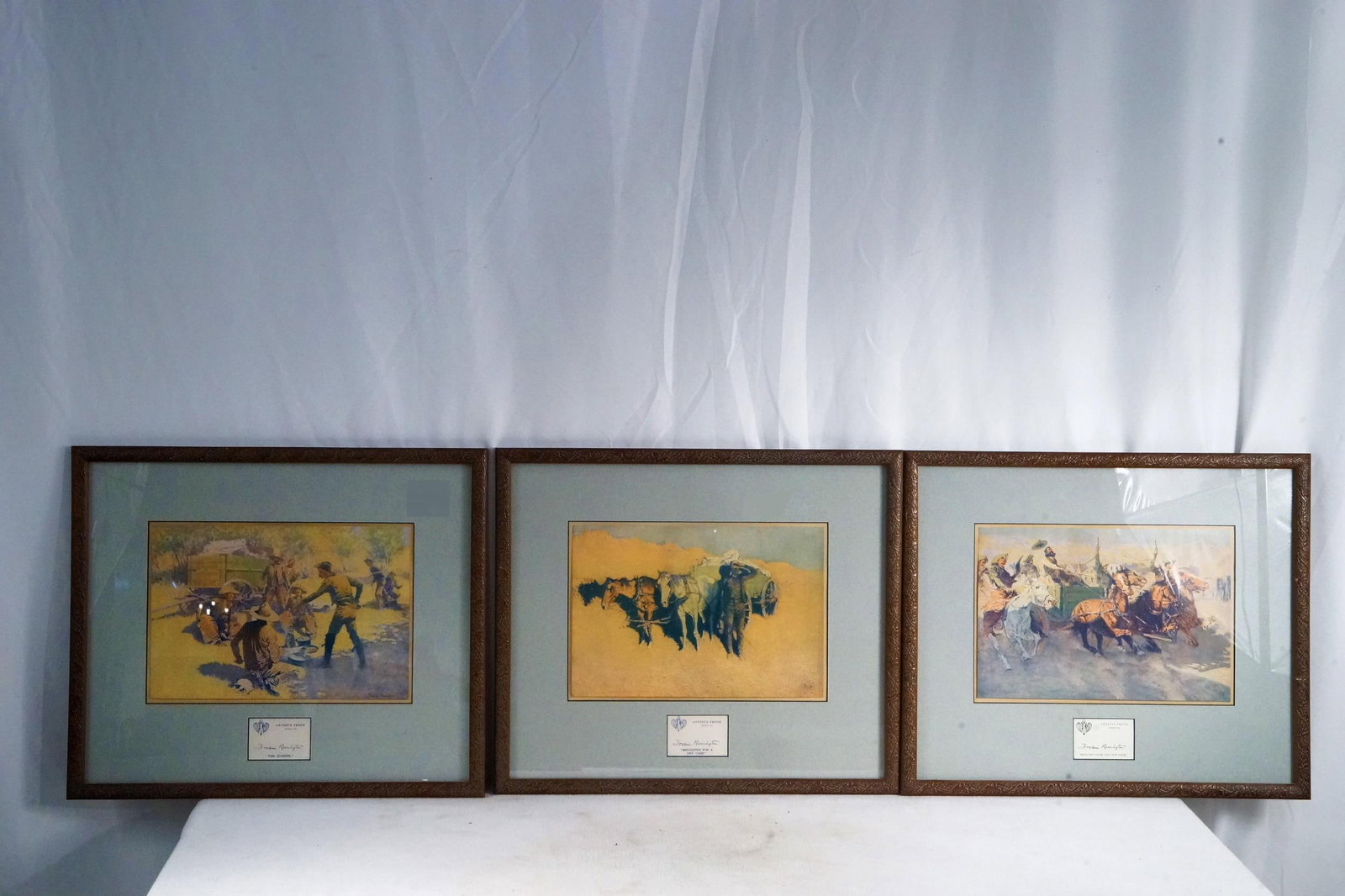 3 Frederick Remington - framed lithographs: The Quarrel and Benighted for a dry Camp + Bring in the cook, - 3 lithos 17" x 19" frame 8.5" x 12.5" lithos Provenance: Museum of the Cowboy, The estate of Jim Grimm and Linda Paich Solvang Ca.