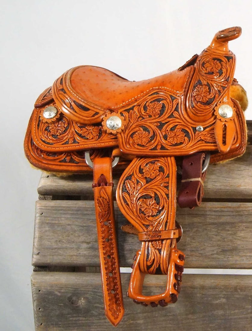 Miniature "Cactus Saddlery" Western saddle: Excellent condition hand tooled leather saddle with silver conchos measures approx. 12" x 8" - 28" from stirrup over the seat to stirrup - Ostrich seat