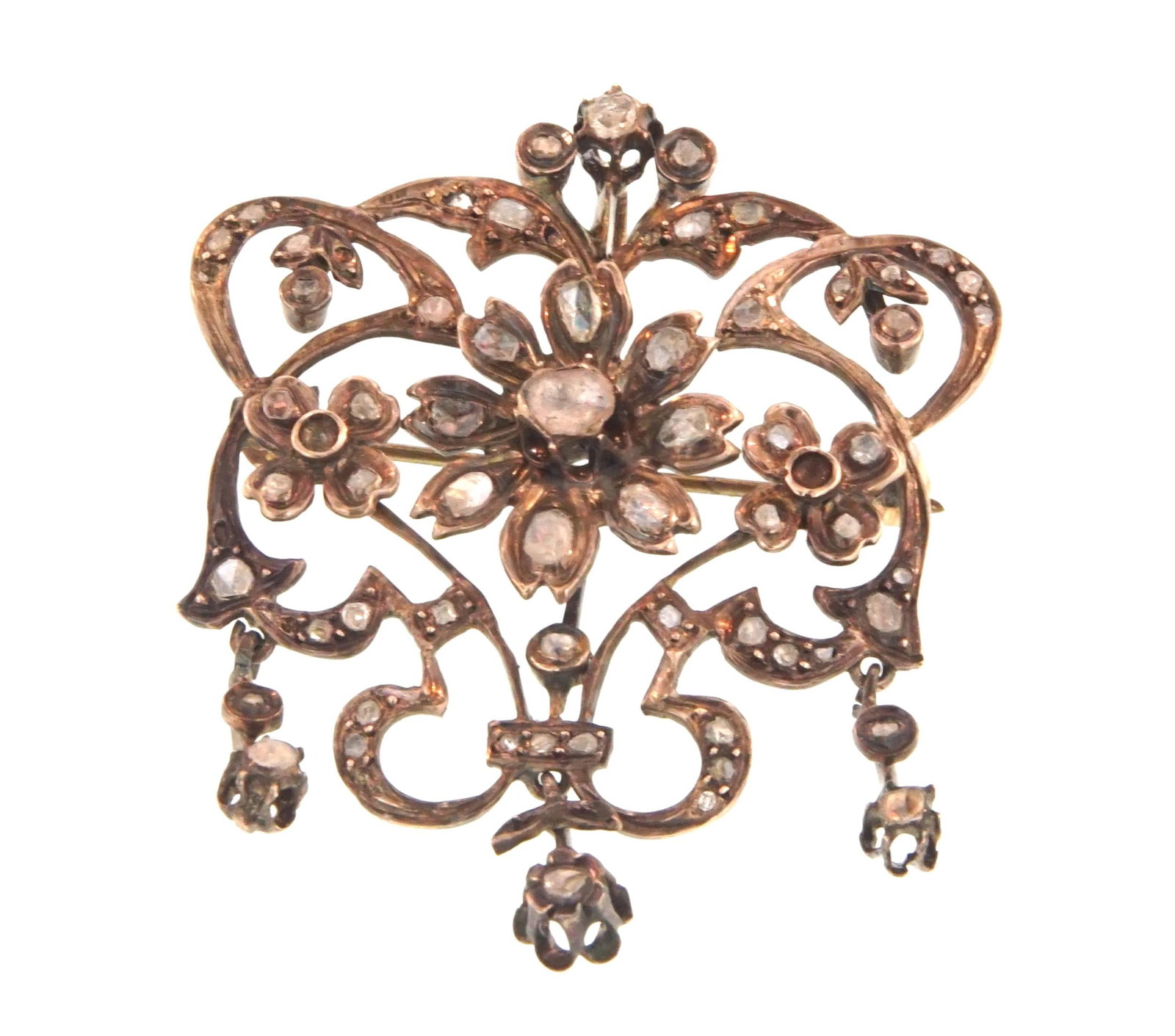 An Antique Diamond Floral Victorian Brooch: A crown like setting with three central florettes and three dangles all containing antique mine cut diamonds (tested), very intricate for a 150 year old tested 10kt rolled gold (over silver) brooch wi