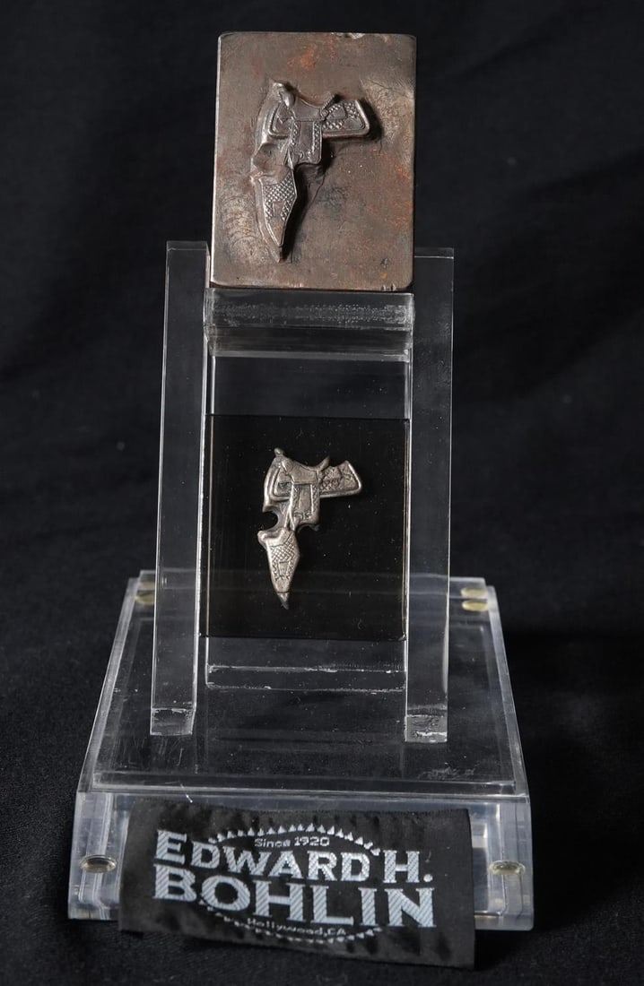 Edward H. Bohlin Leather & Silver dye's: Edward H. Bohlin Leather & Silver dye's The Plexiglas presentation measures approx. 8" x 4" x 6" and contains a Bohlin Silver Dye, a a matching Silver Saddle Concho, also includes a Leather Punch for