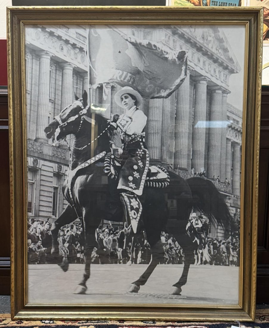 Photograph of Parade Horse and Lady Rider NYC: A female parade rider dressed in the traditional men's conjunto charro attire similar to Western riders in the Santa Barbara Fiesta riding a heavily armored Western Parade Saddle in front of the Natio