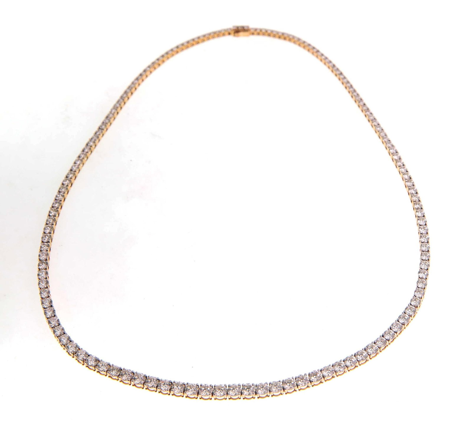 Ladies18kt Gold 12.4 VVS Diamond Riviera Necklace: A ladies diamond Riviera tennis necklace crafted in solid 18kt yellow gold. The necklace is structured with a continuous graduating line of round brilliant-cut natural diamonds set within individual m