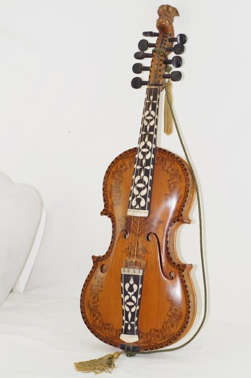 Hardanger fiddle - Norwegian highly inlaid: finely crafted mother of pearl inlaid and rosing - pine top and maple back. - Four of the strings are strung and played like a violin, while the rest, aptly named understrings or sympathetic strings, 