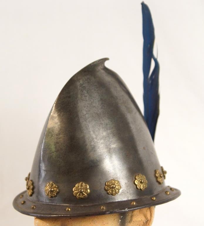 Italian style embossed foot soldiers Cabasset: Italian/ Spanish style foot soldiers helmet in excellent displayable condition. Typical crowning spike, plume holder and riveted brass flowers spaced above the rim. Firm forged Iron. Measures approx 2