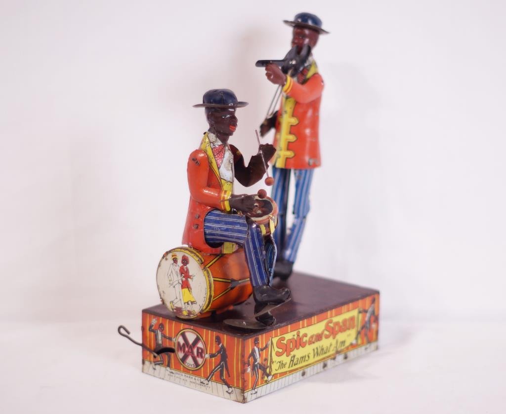 Spic & Spam - The band that Am! L Marx: tin toy windup 1924- Louis Marx, lithographed tin, depicts two minstrels, one playing cymbals and drums, and the other on the fiddle, works, well detailed toy. 10 1/4" h Provenance: Important Californ