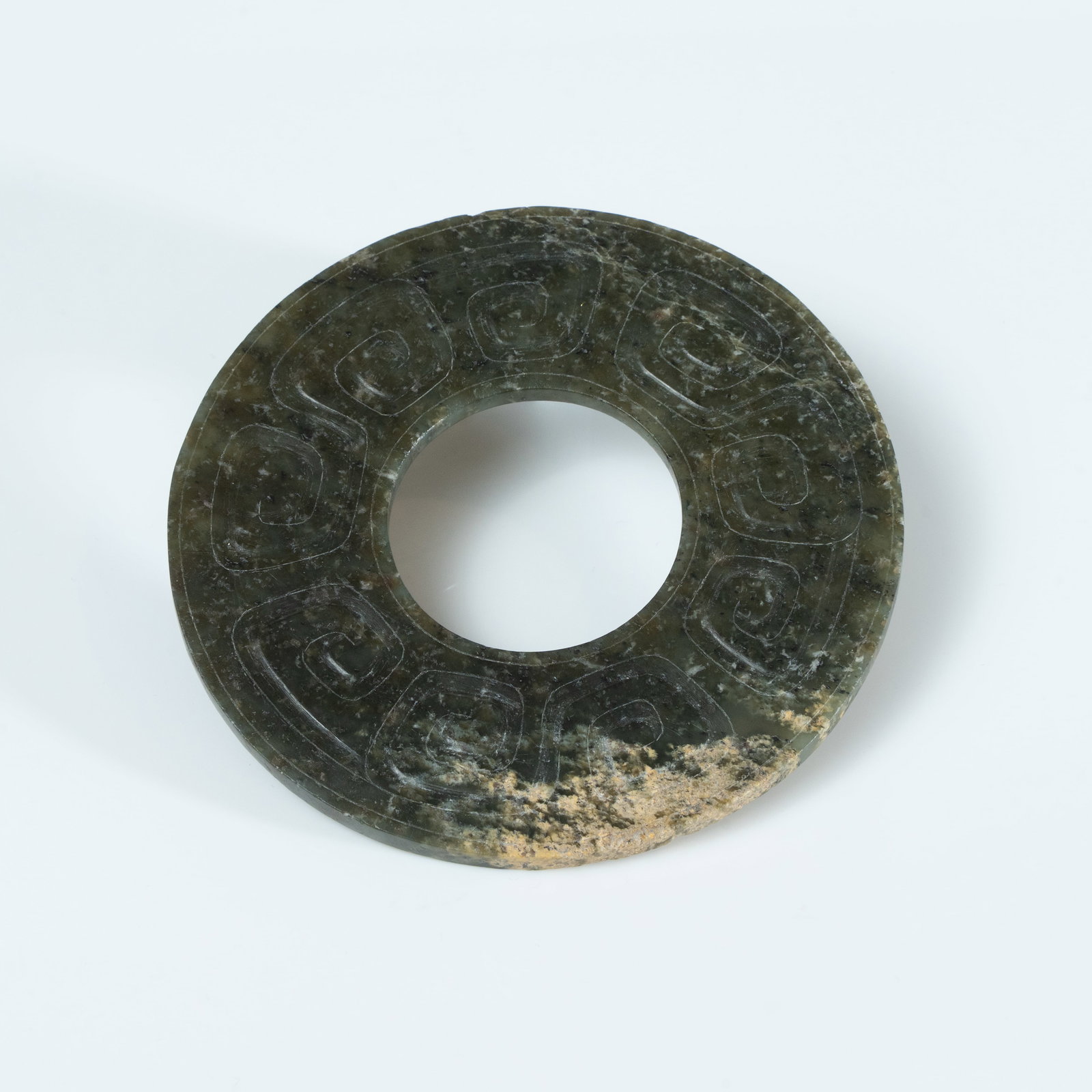 A LARGE ARCHAISTIC CELADON JADE 'CLOUD AND THUNDER' BI-DISC HAN DYNASTY OR LATER (1 of 3)