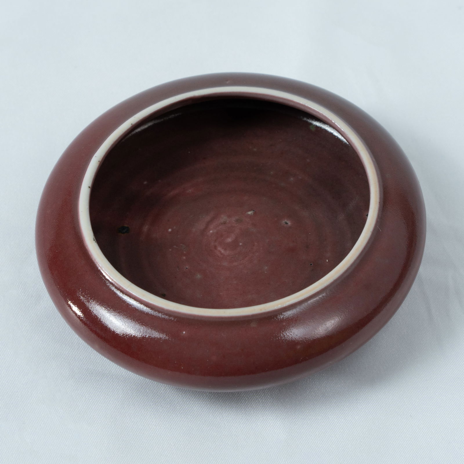 A SACRIFICIAL RED-GLAZED 'ALMS-BOWL' SHAPED BRUSH WASHER LATE QING DYNASTY – REPUBLIC PERIOD,: A SACRIFICIAL RED-GLAZED 'ALMS-BOWL' SHAPED BRUSH WASHERLATE QING DYNASTY – REPUBLIC PERIOD, XUANDE MARK晚清至民国 祭红釉钵式洗&
