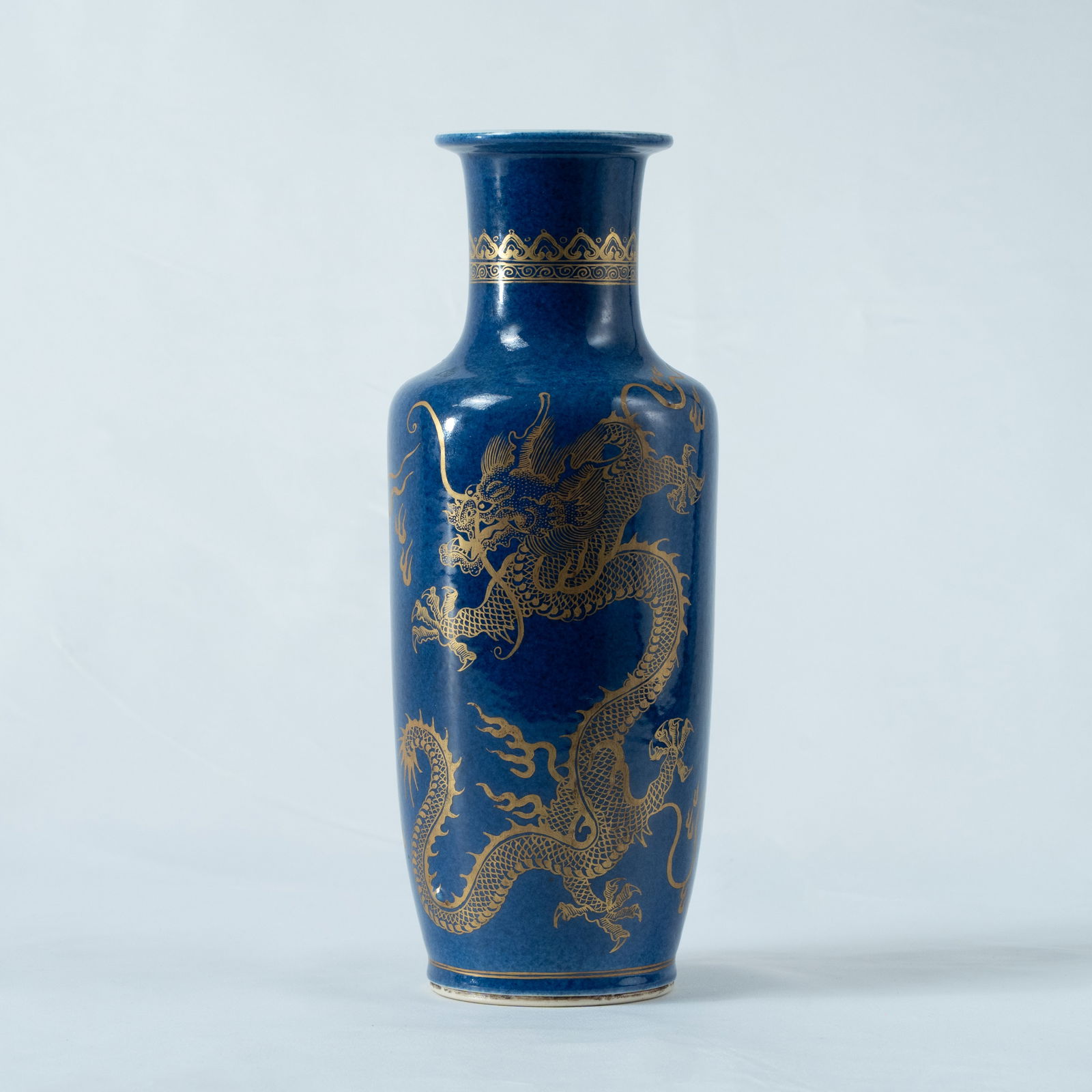 A POWDER-BLUE GLAZED AND GILT-DECORATED 'DRAGON' CLUB-SHAPED VASE QING DYNASTY: A POWDER-BLUE GLAZED AND GILT-DECORATED 'DRAGON' CLUB-SHAPED VASEQING DYNASTY清 洒蓝釉描金云龙纹棒槌瓶MEASUREMENTSH. 25.9 cm, 10