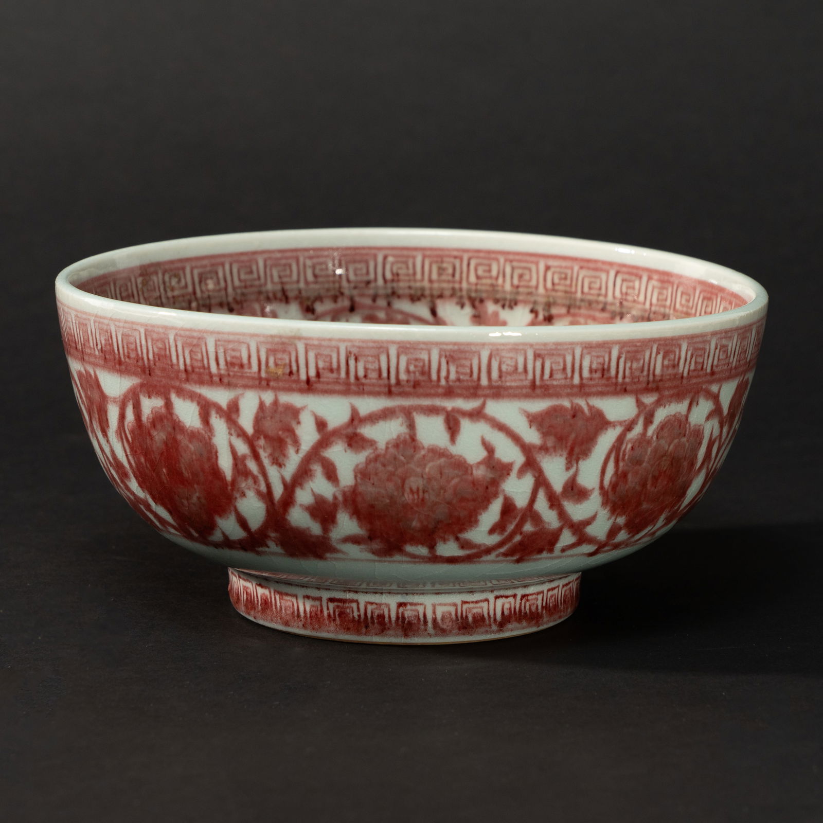 AN UNDERGLAZE-RED 'FLORAL SCROLL' BOWL MING DYNASTY, 14TH - 15TH CENTURY (1 of 3)