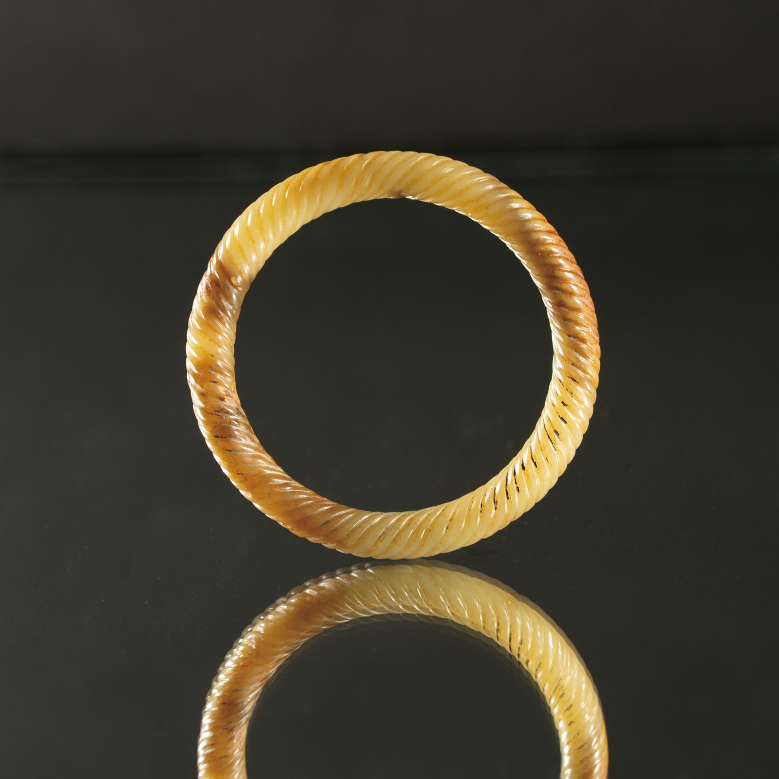 A RARE YELLOW JADE 'TWISTED ROPE' BANGLE WARRING STATES PERIOD (475–221 BC) 战国 (1 of 4)