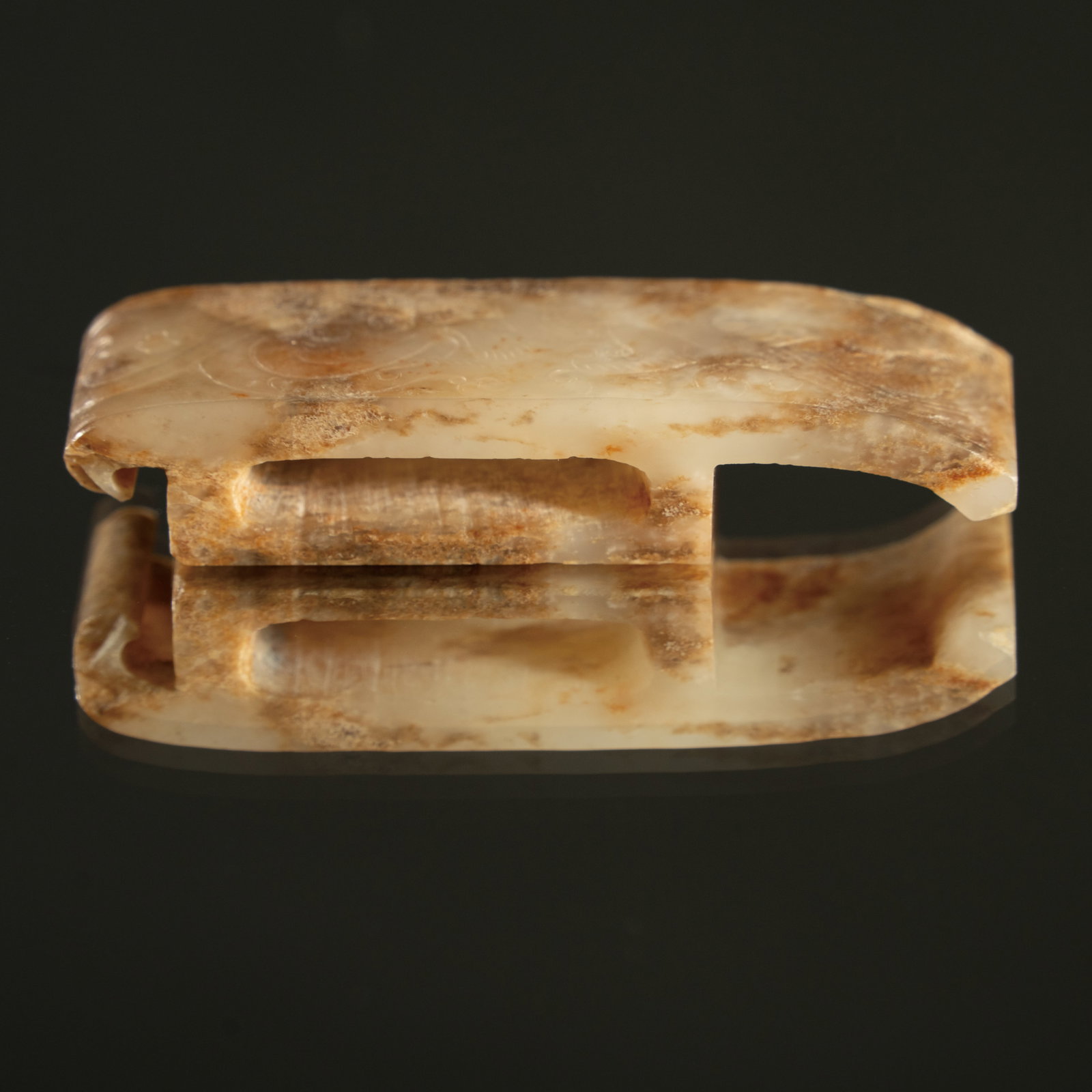 A WHITE JADE SCABBARD SLIDE (WEI) HAN DYNASTY (206 BC–220 AD) 汉代 兽面: A WHITE JADE SCABBARD SLIDE (WEI)HAN DYNASTY (206 BC–220 AD)汉代 兽面纹玉剑璏ESTIMATE: $5,000 – $8,000DescriptionThis elegantly carved white