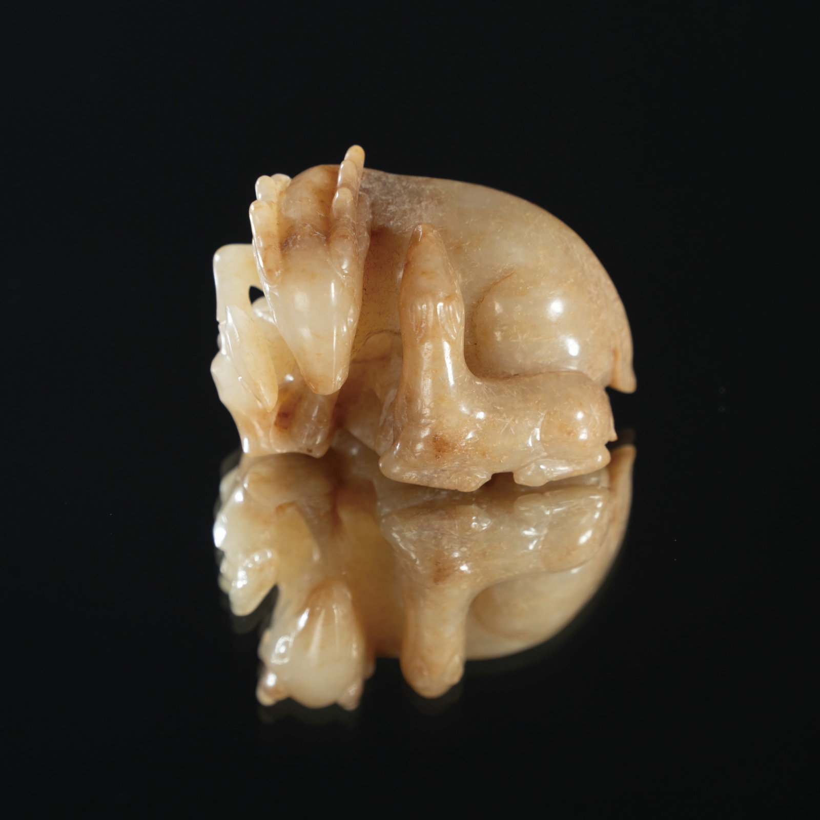 A PALE CELADON AND RUSSET JADE 'MYTHICAL BEAST' PAPERWEIGHT MING DYNASTY (1368–1644) OR LATER (1 of 3)