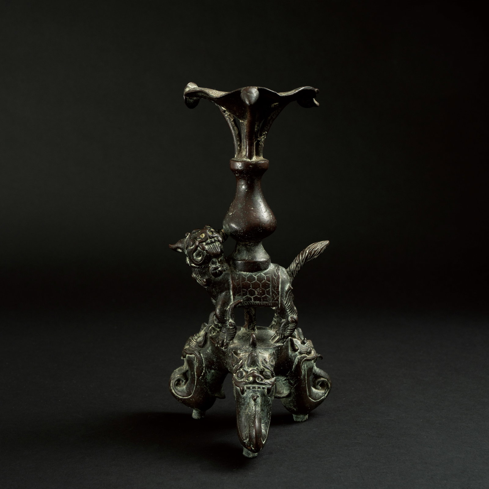 A RARE BRONZE 'MYTHICAL BEAST' CANDLE HOLDER SONG DYNASTY 宋 铜瑞兽驮: A RARE BRONZE 'MYTHICAL BEAST' CANDLE HOLDERSONG DYNASTY宋 铜瑞兽驮宝瓶烛台ESTIMATE: $10.000 – $20.000DescriptionThis rare bronze candle hol