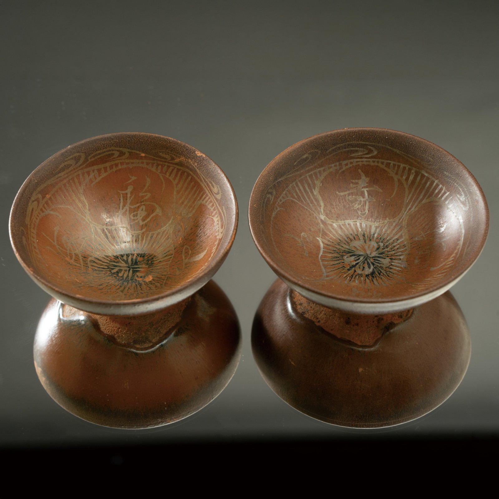A PAIR OF PERSIMMON-GLAZED 'AUSPICIOUS CHARACTERS' TEA BOWLS SOUTHERN SONG DYNASTY, YULIN KILN (1 of 6)