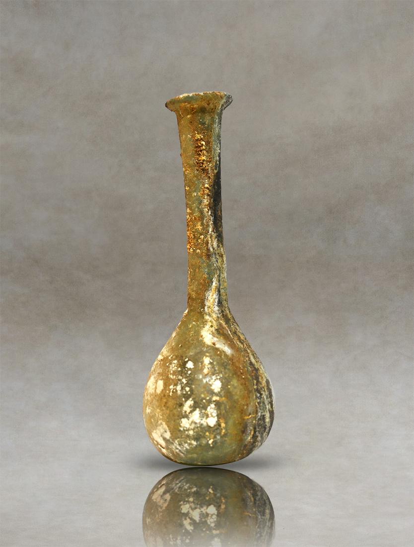 Roman Ribbed Glass Bottle, 1st-2nd Century AD: Intact translucent, pale green Roman glass unguentarium with vertical ribs along the piriform body. Small constriction at the join to the cylindrical neck. The flared mouth with inward folded rim. Sta