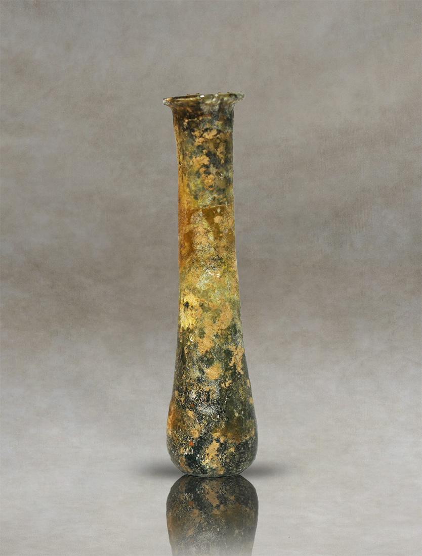 Well patinated Roman Glass Unguentarium Perfume Bottle: Ancient Roman glass perfume holder. It has a pyriform body, with a small narrowing at the base of the cylindrical neck and an outward-folding rim. fully covered with iridiscenses in dark tone.Inventor