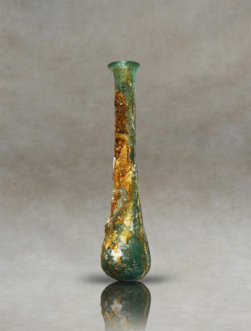 Roman Glass Unguentarium: Presenting an exceptional Roman unguentary crafted from meticulously blown pale blue glass. This distinguished artifact, believed to have functioned as a perfume bottle in ancient times, embodies the