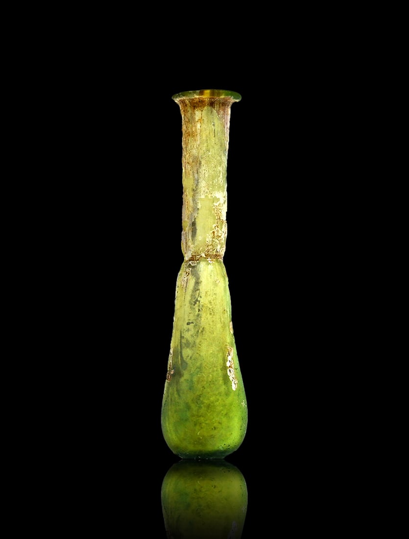 Roman Glass Unguentarium Perfume Bottle: An ancient Roman unguentarium formed from turquoise glass. It features a piriform-shaped body, with a constriction at the base of the cylindrical neck and an everted, folded rim. The base is flattened