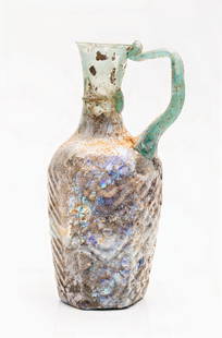 Ancient Roman Glass Jug of Extraordinary Craftsmanship and Condition. A Museum Quality Piece, 18.7: Ancient Roman Glass Jug of Extraordinary Craftsmanship and Condition. A Museum Quality Piece, 18.7 cm. Single-handled, six-sided jug with each "panel" having a design such as grapes, palms, and geomet