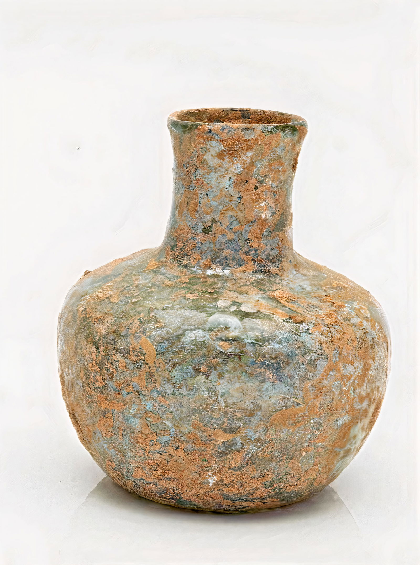 Roman Glass Flasks. Roman 2nd-3rd Century C.E.: Glass Flasks. Roman 2nd-3rd Century C.E. Global short neck flask of light greenish-blue partially covered with debris, 8. cm.