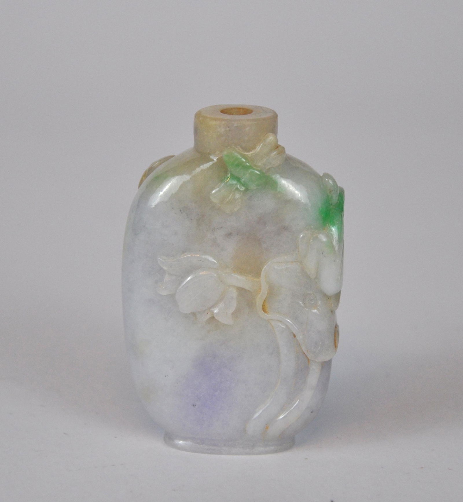 A Chinese jade snuff bottle carved with lotus, lavender & green hue, 19/20th C. (1 of 5)