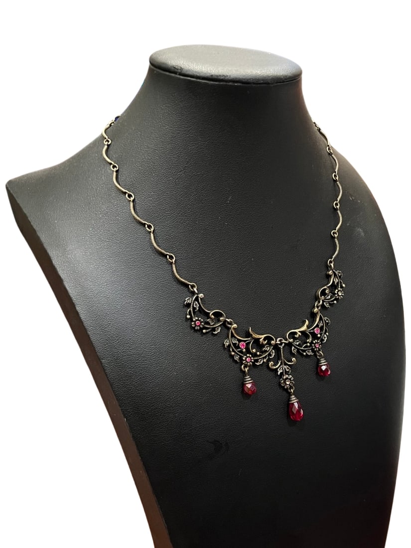 Aged Gold Antique Victorian Collar Bone Ruby Drop Necklace: This incredible Aged Gold Antique Victorian Collar Bone Ruby Drop Necklace is like a true piece from a princess film! The aged gold is set in a swirling, curling, twine drop shape that leads to the ce