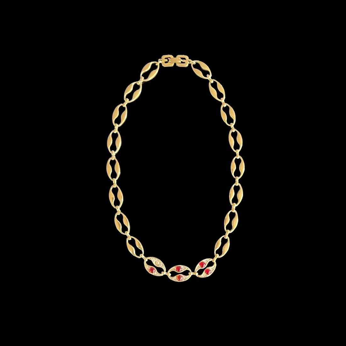 Vintage Givenchy Gold Tone Red Rhinestone Collar Bone Necklace: This Vintage Givenchy Gold Tone Red Rhinestone Collar Bone Necklace is in very good overall condition, however, is missing one red stone as seen in the 1st photograph. The necklace comes in a protecti