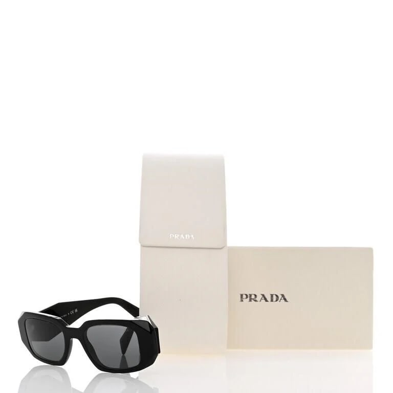 Prada Black Acetate Symbole Sunglasses SPR 17W: This pair of Prada Sunglasses SPR 17W in Black is a stylish and sophisticated accessory. The black frames feature squared rims and dark grey lenses, giving them an elegant look. The geometric arms hav