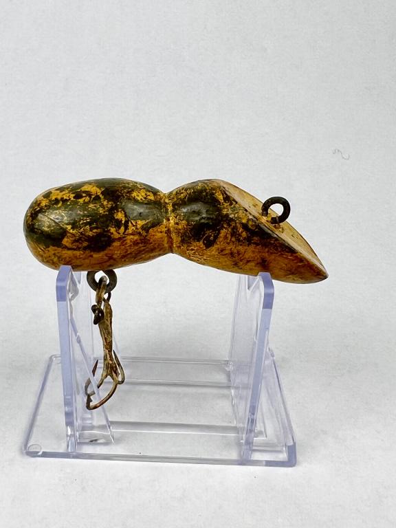 Antique fishing lure: Carved and painted wood fishing lure. Condition: Age discoloration, paint on hooks, slight crack on underside. Dimensions: L 3"