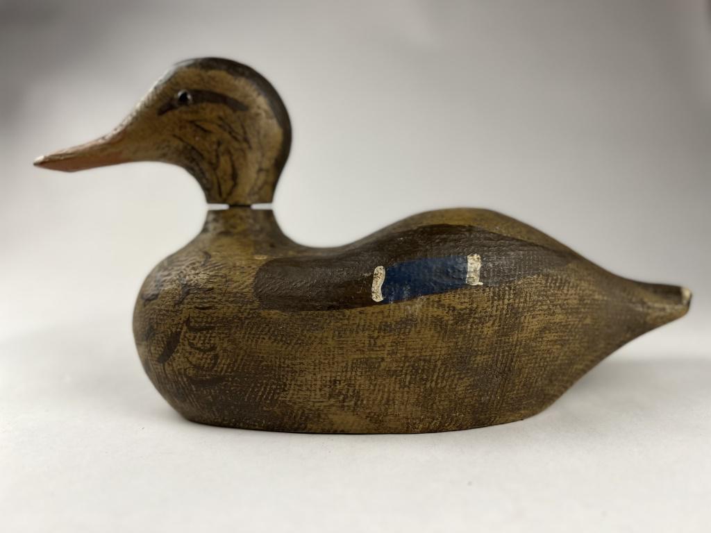 Duck Decoy: Antique painted wood duck decoy, unsigned. Condition: Head swivels, minor losses to paint. Dimensions: H 7.5" x L 13.5" x W 5"