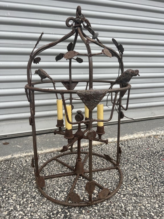 Whimsical Iron chandelier: Rusty, whimsical chandelier, bird cage design with leaves and birds. Dimensions: H 26.5" x Dia: 16" Condition: Wiring present, likely needs rewiring. Missing a few scattered leaves.