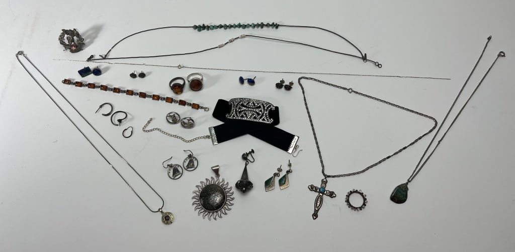 Sterling silver jewelry grouping: A grouping of vintage sterling silver jewelry. Including a MMA jeweled choker, (2) thin Native American necklaces including bone and shell, two amber rings and an amber bracelet, a southwestern turquo