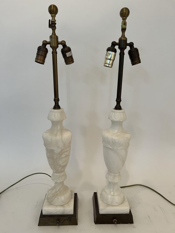 Pair of carved alabaster lamps: White alabaster and brass bases. Dimensions: To finial: H 31" x W (base) 6" Condition: Only minor chips to the edges. 173