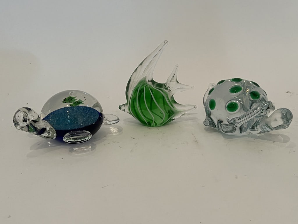 (3) Sea life glass sculpture paperweights: All unsigned, two turtles and a fish. Dimensions: Fish: H 5" x W 5" Condition: Minimal scratching. 163