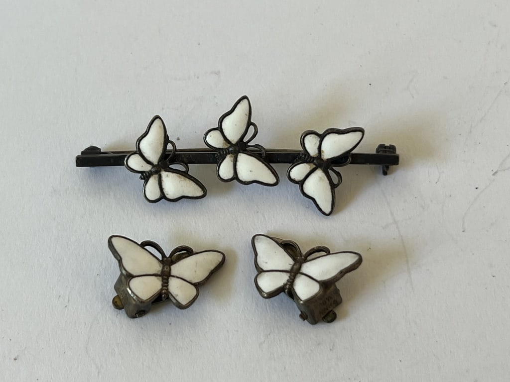 Sterling Scandinavian enamel butterfly jewelry: Sterling silver and white enamel, hallmarked 925 S. Dimensions: Brooch: L 2.25" Weight: 11 grams Condition: Presenting nicely.
