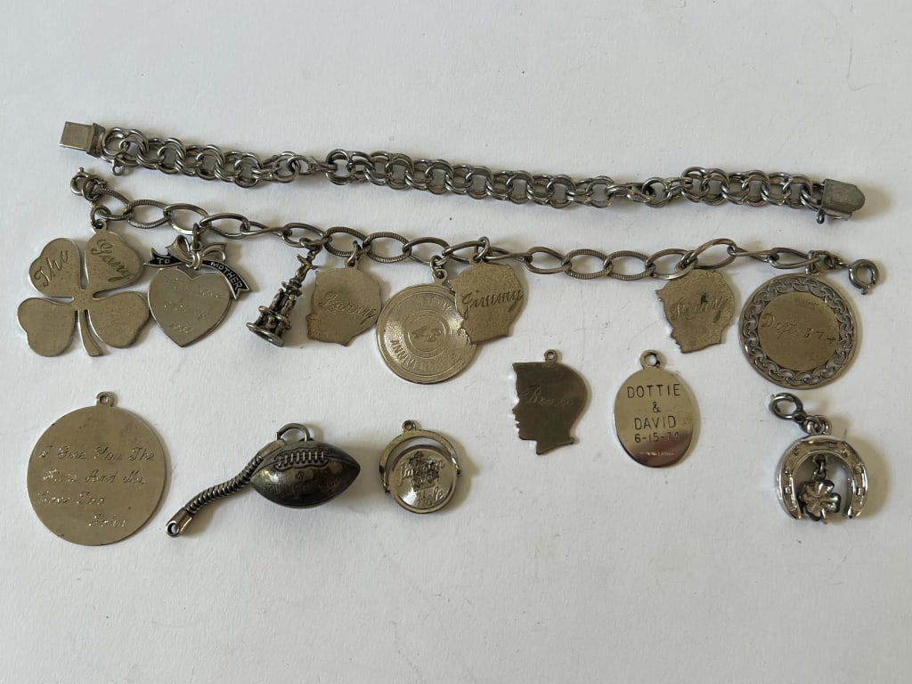 (2) Sterling silver charm bracelets and charms: 2 vintage sterling silver charm bracelets with sterling silver charms. Dimensions: L 7.5" Total weight: 79 grams. Condition: Good, vintage, minor wear, wearable.