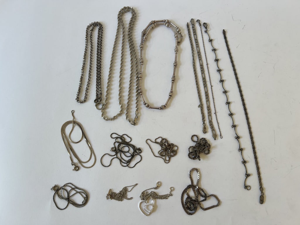 Sterling silver chain necklaces: Grouping of 11 sterling silver chain necklaces and 5 sterling silver chain bracelets. All hallmarked. Dimensions: Longest: 24" long Total weight: 100 grams