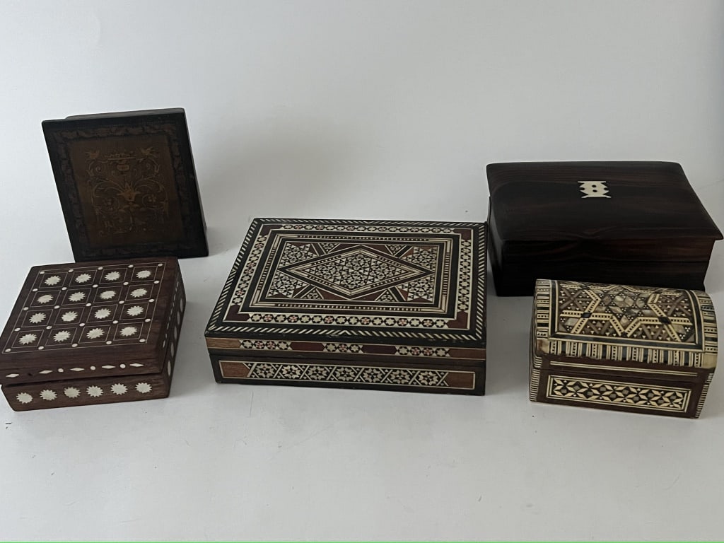 Grouping of 5 inlaid boxes: (5) vintage and antique boxes with marquetry, bone and other of pearl inlay. Dimensions: Largest: L 7" x W 5.25" Condition: Minor losses to inlay, all with mark ups to bottom.
