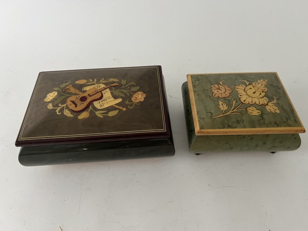 (2) Italian inlaid jewelry and music boxes: A musical jewelry box and a music box. Dimensions: Larger: L 6" x W 4.25" x H 2.25" Condition: Smaller missing its glass, both working, marker to bottom.